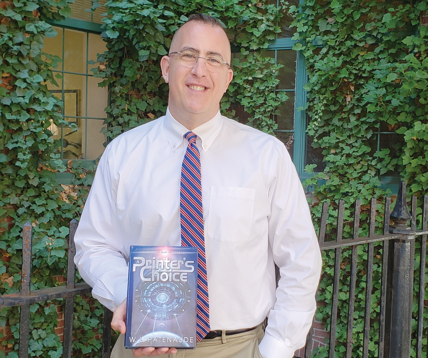 William Patenaude with his recently released book entitled “A Printer’s Choice,” a murder-mystery novel set in outer space.